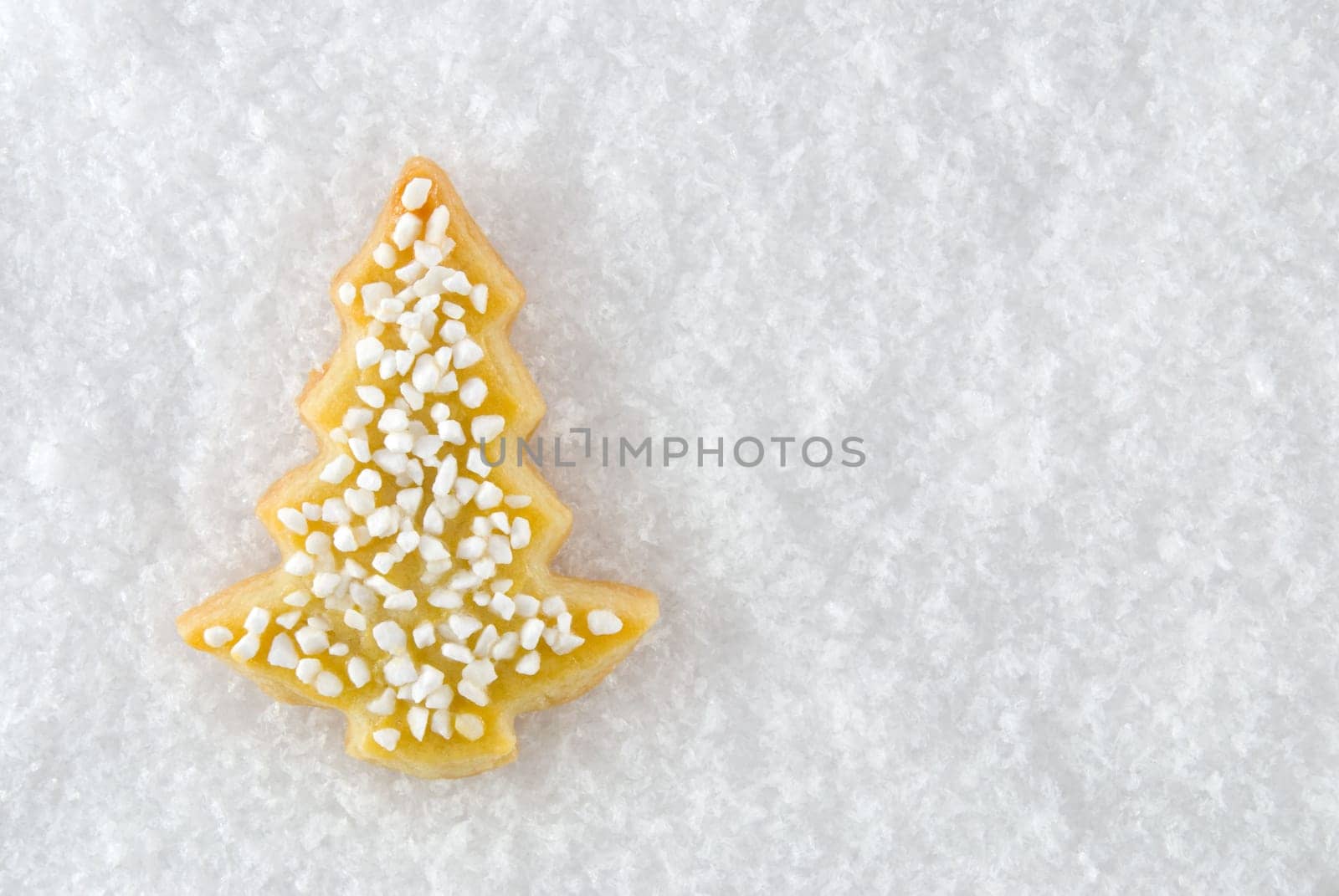 a christmas tree cookie as christmas decoration or as card motif, lying in the