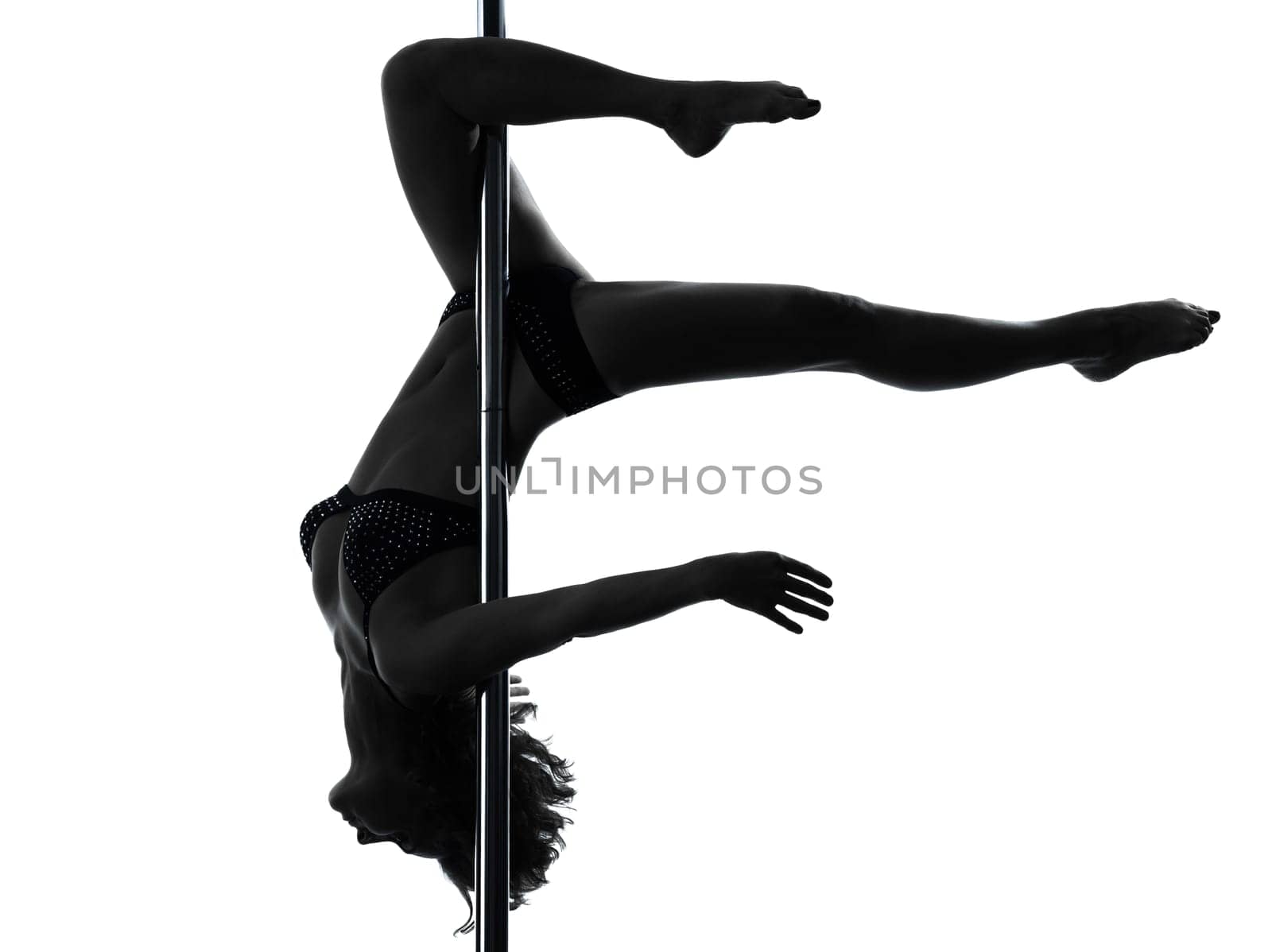 one caucasian woman pole dancer dancing in silhouette studio isolated on white background