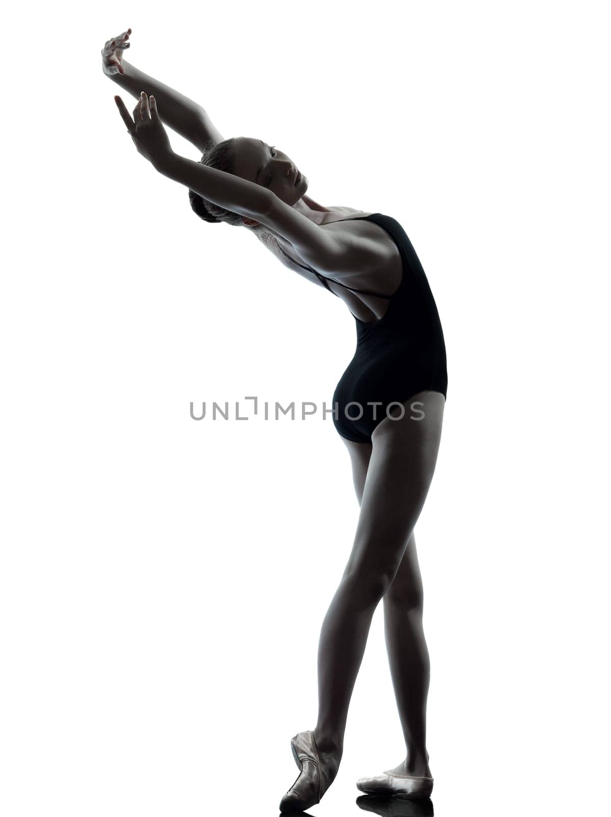 one caucasian young woman ballerina ballet dancer stretching warming up in silhouette studio on white background