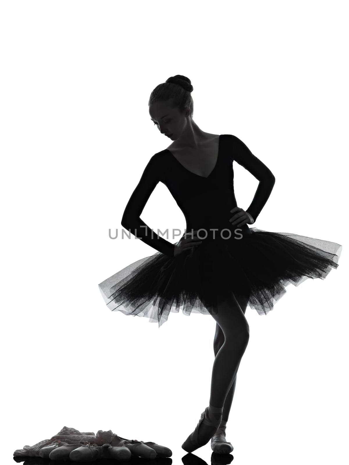 one caucasian young woman ballerina ballet dancer dancing with tutu in silhouette studio on white background