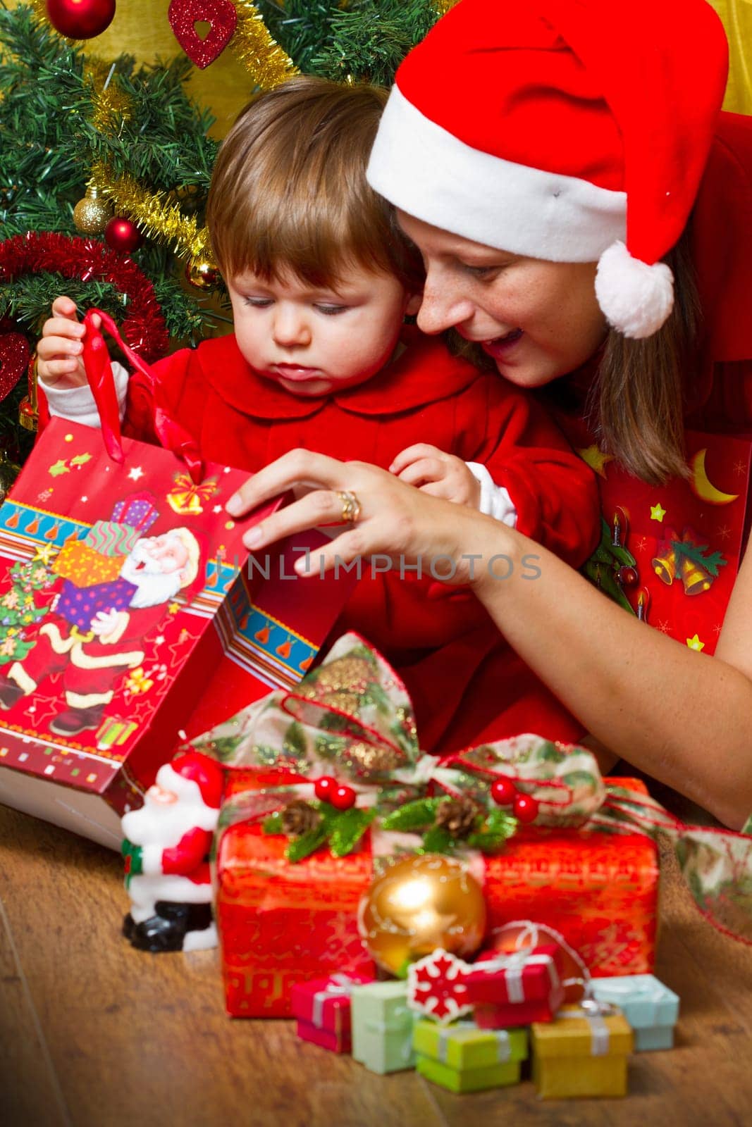 Young mother with  baby  at Christmas tree