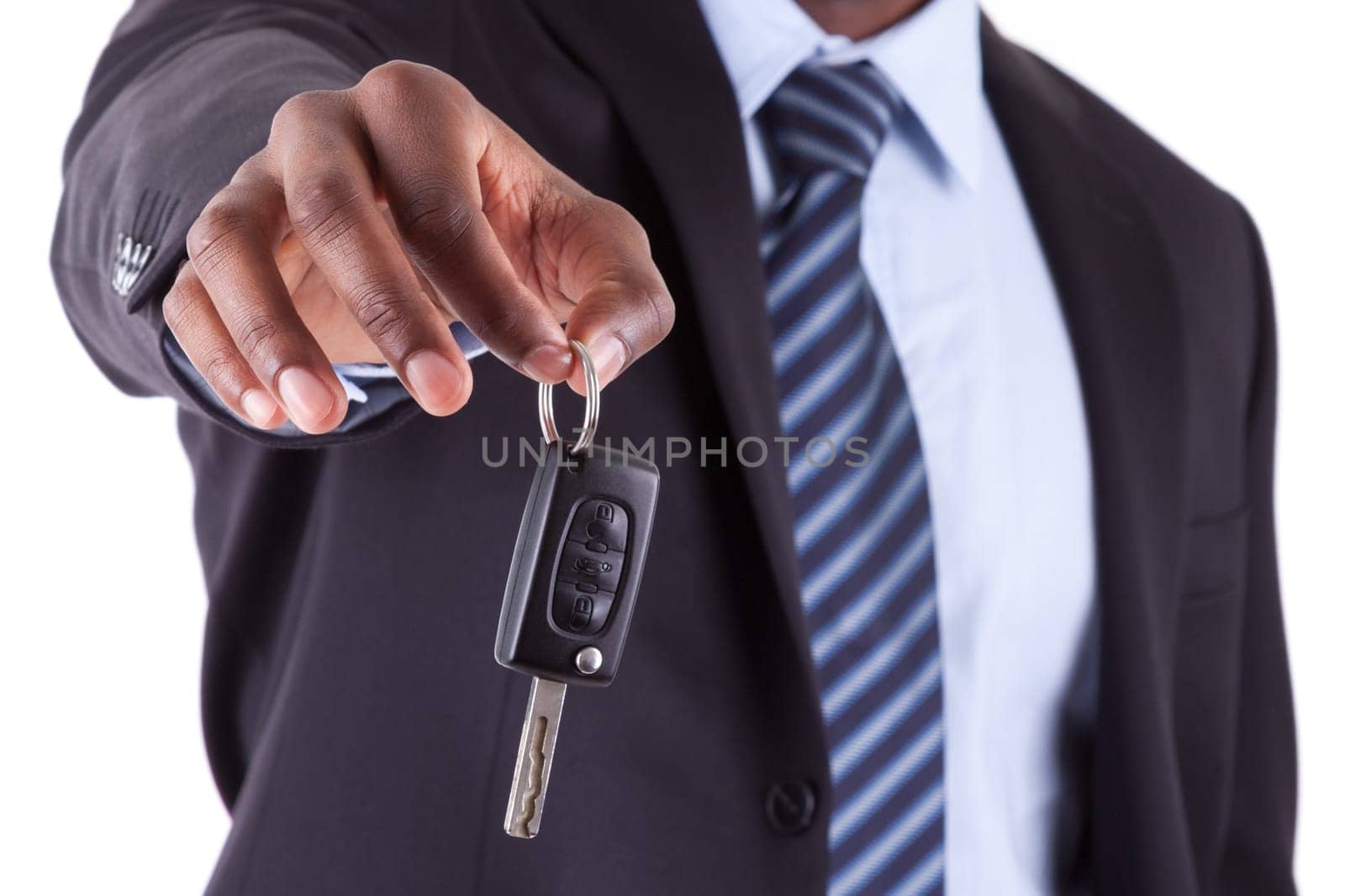 Young African American businessman holding a car key,isolated on white background