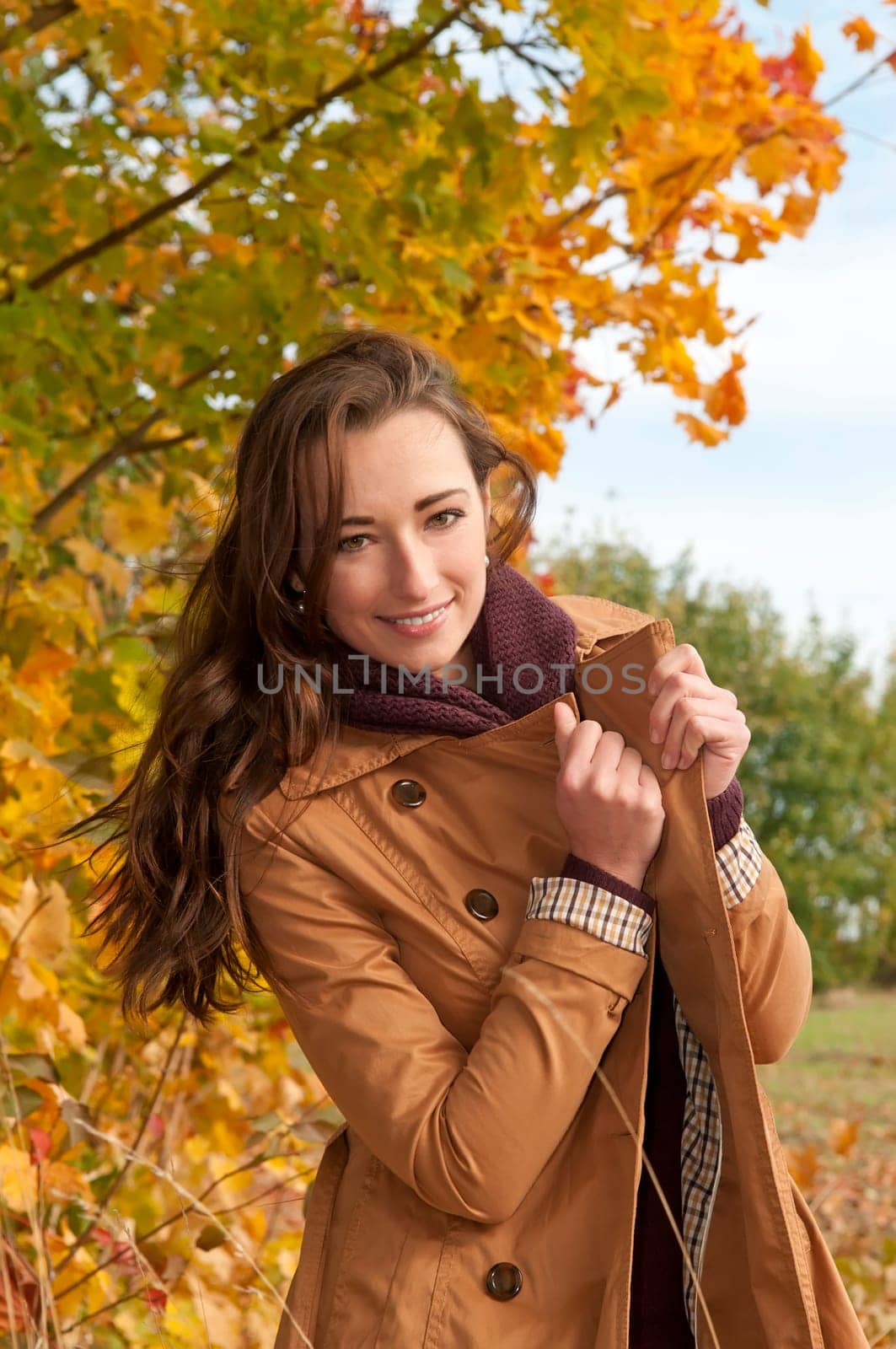 Happy young woman in autumnal park