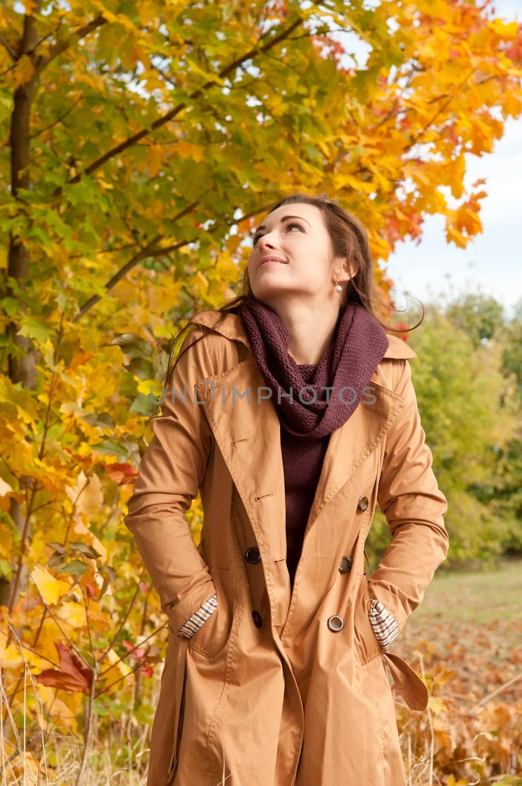 Happy young woman in autumnal park