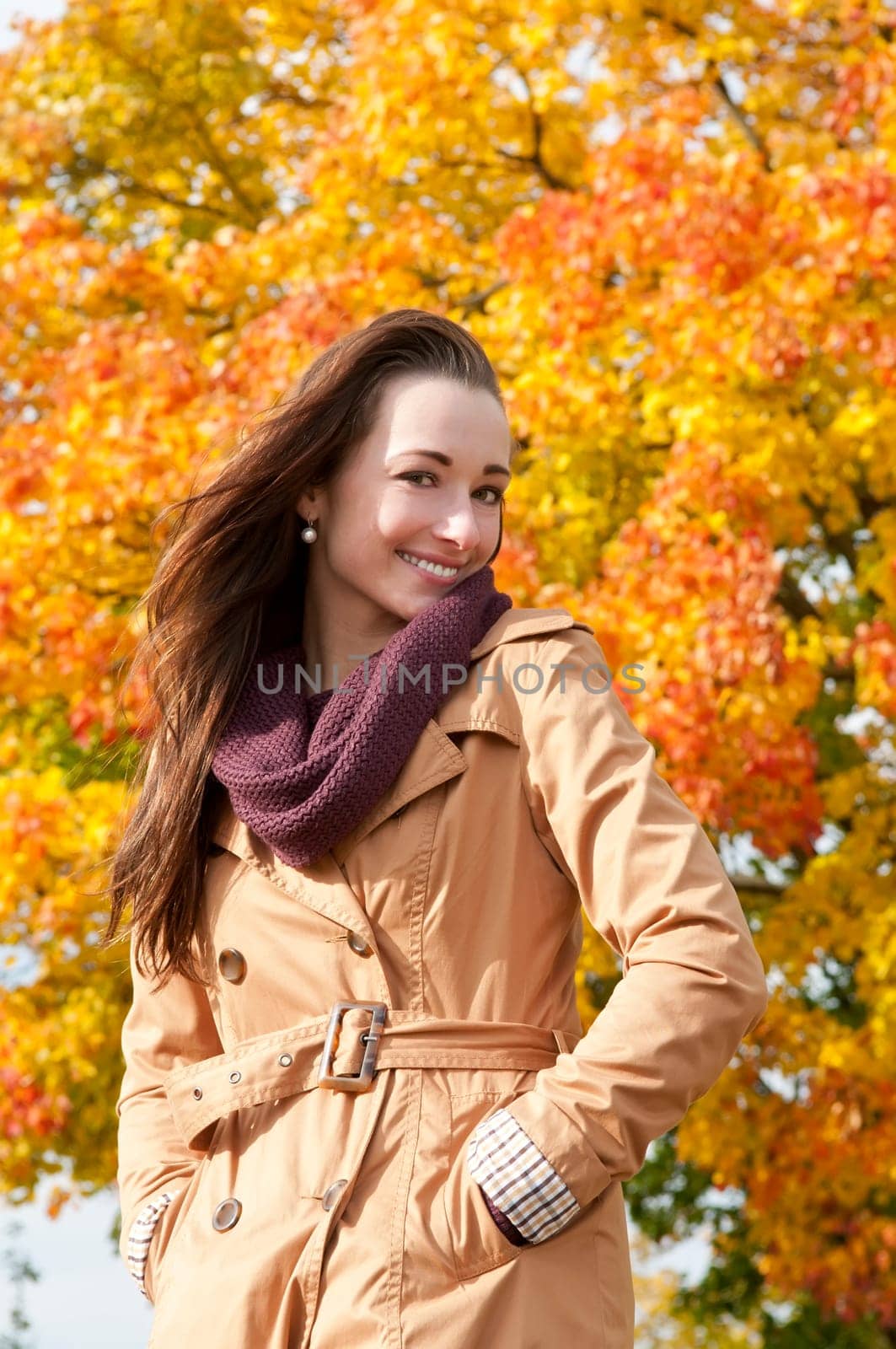 Cheerful young woman in autumnal park