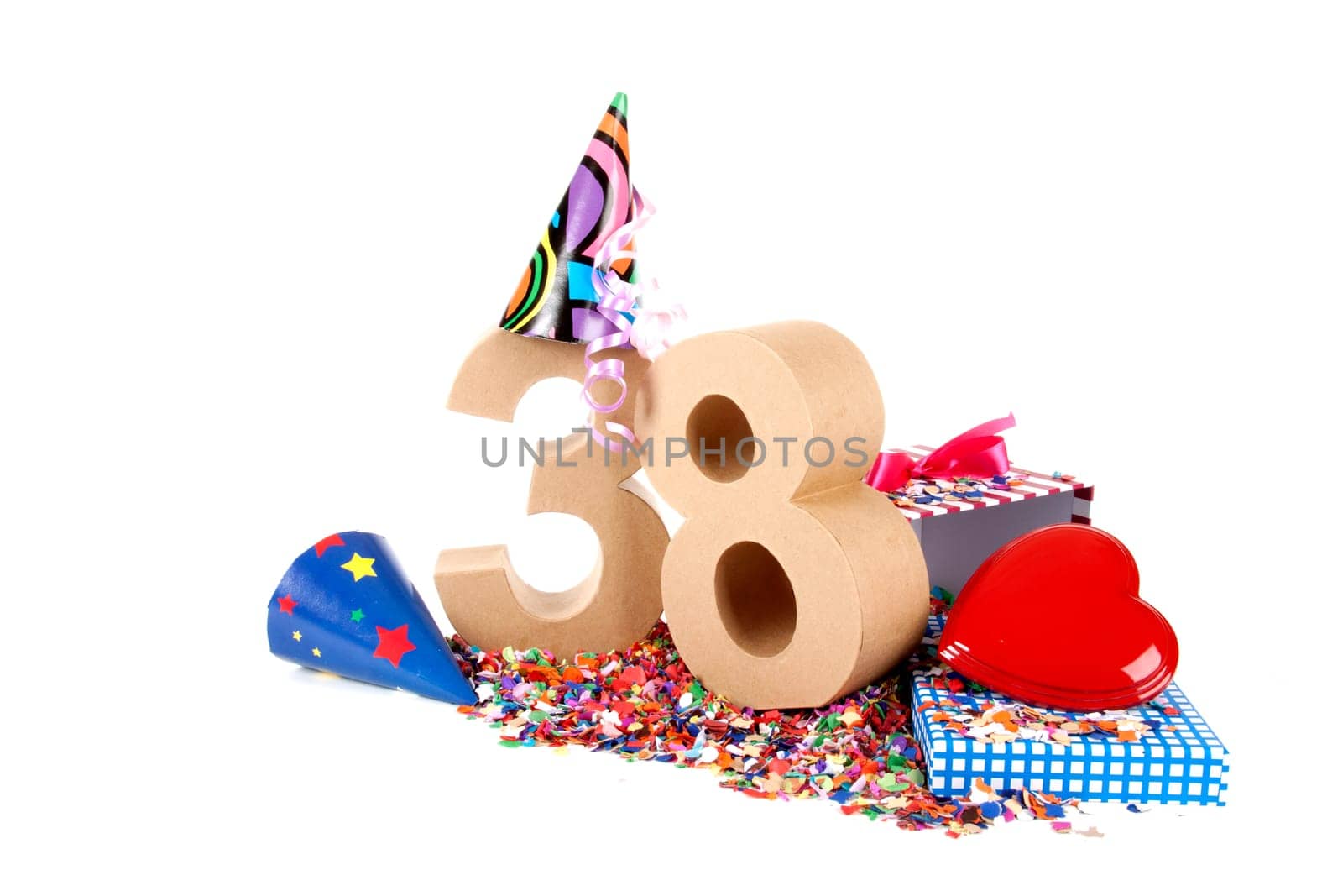 Number of age in a colorful studio setting with paper party hats, a red heart and gifts on a bottom of confettie