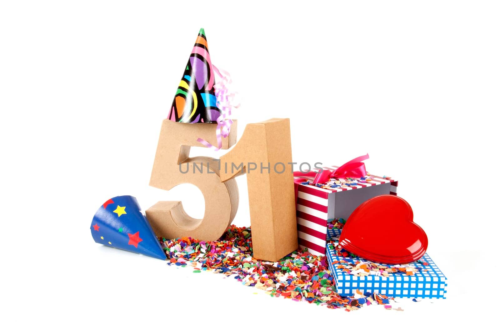 Number of age in a colorful studio setting with paper party hats, a red heart and gifts on a bottom of confettie