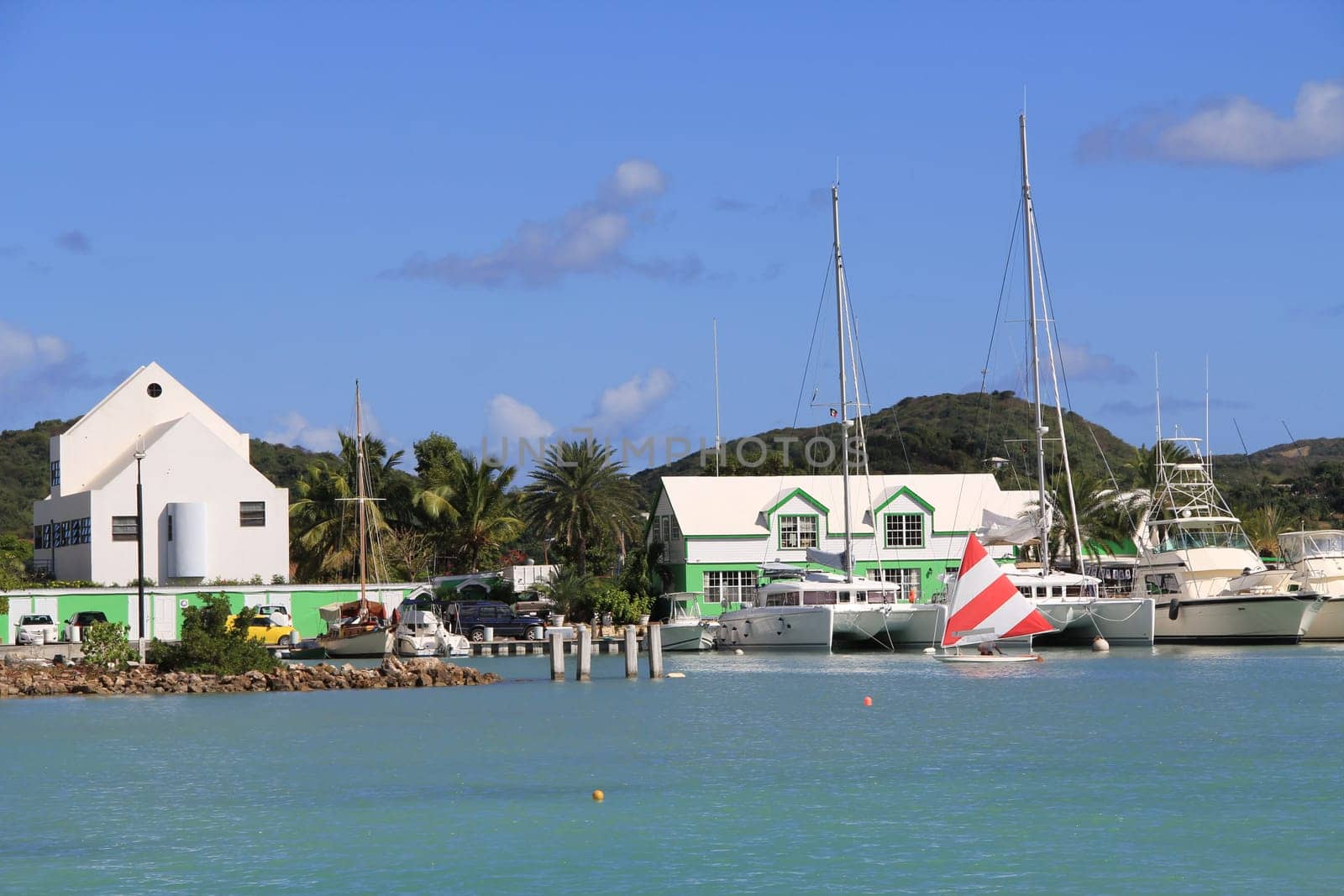 Wind surfer sailing in Falmouth Harbour Marina in Antigua Barbuda.