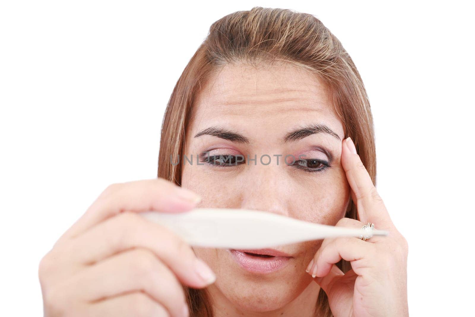 Sick woman looking at a clinical thermometer
