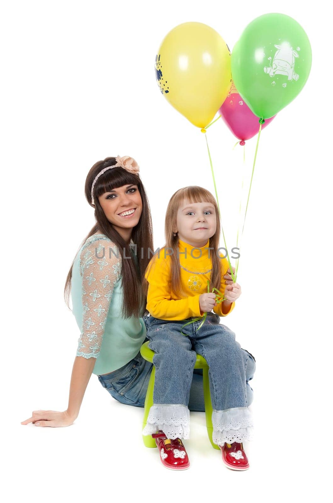 Mother and his daughters with colorful balloons. studio shoot over white background
