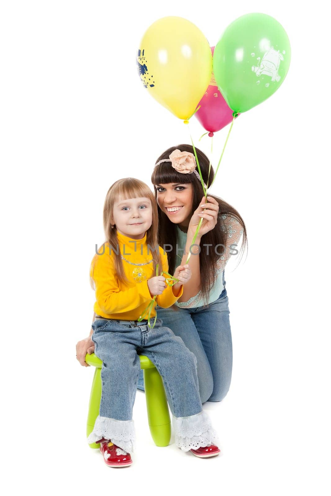 Mother and his daughters with colorful balloons. studio shoot over white background