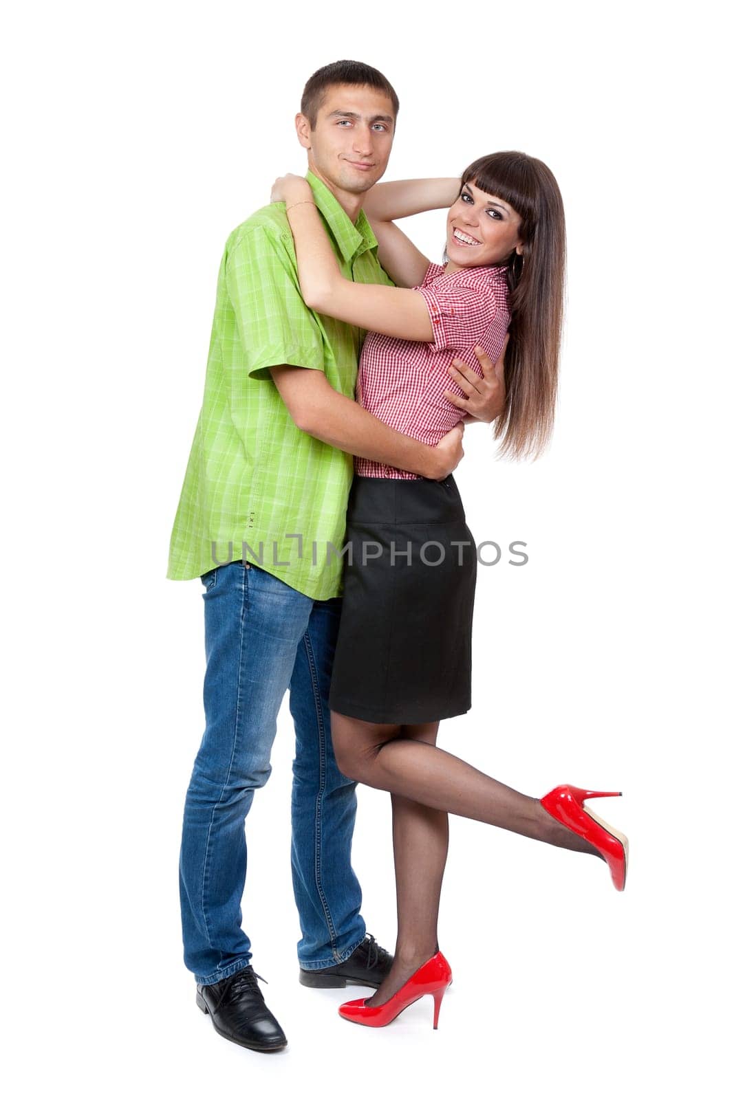 Full-length portrait of a young couple in love in the studio. Isolate on white.