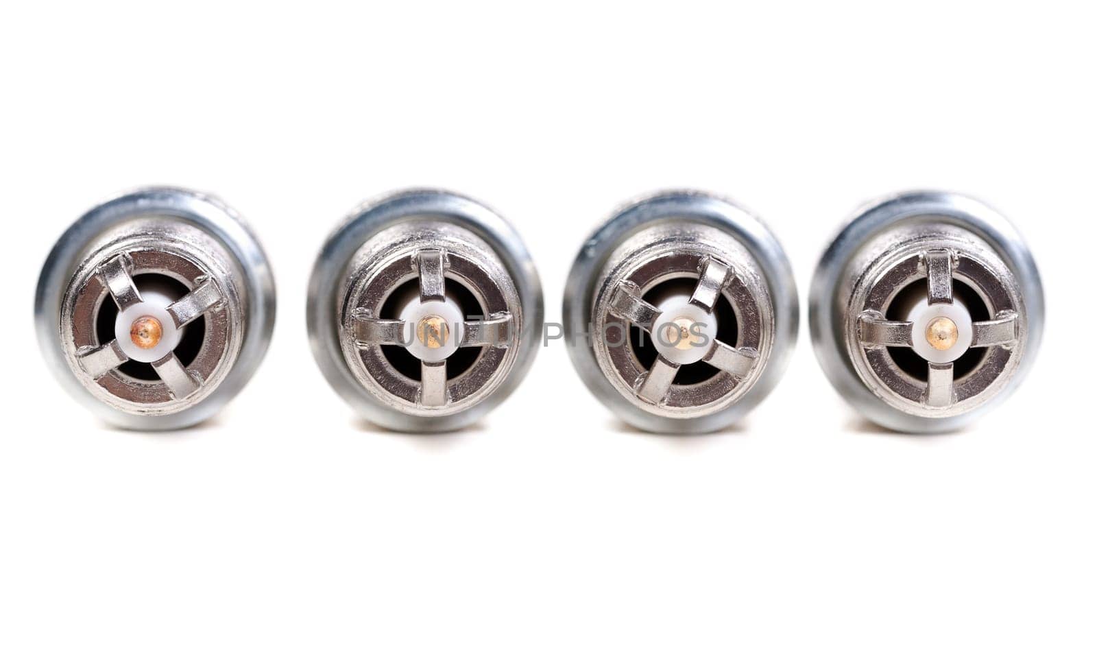 Four spark plugs the car close-up view from the electrodes