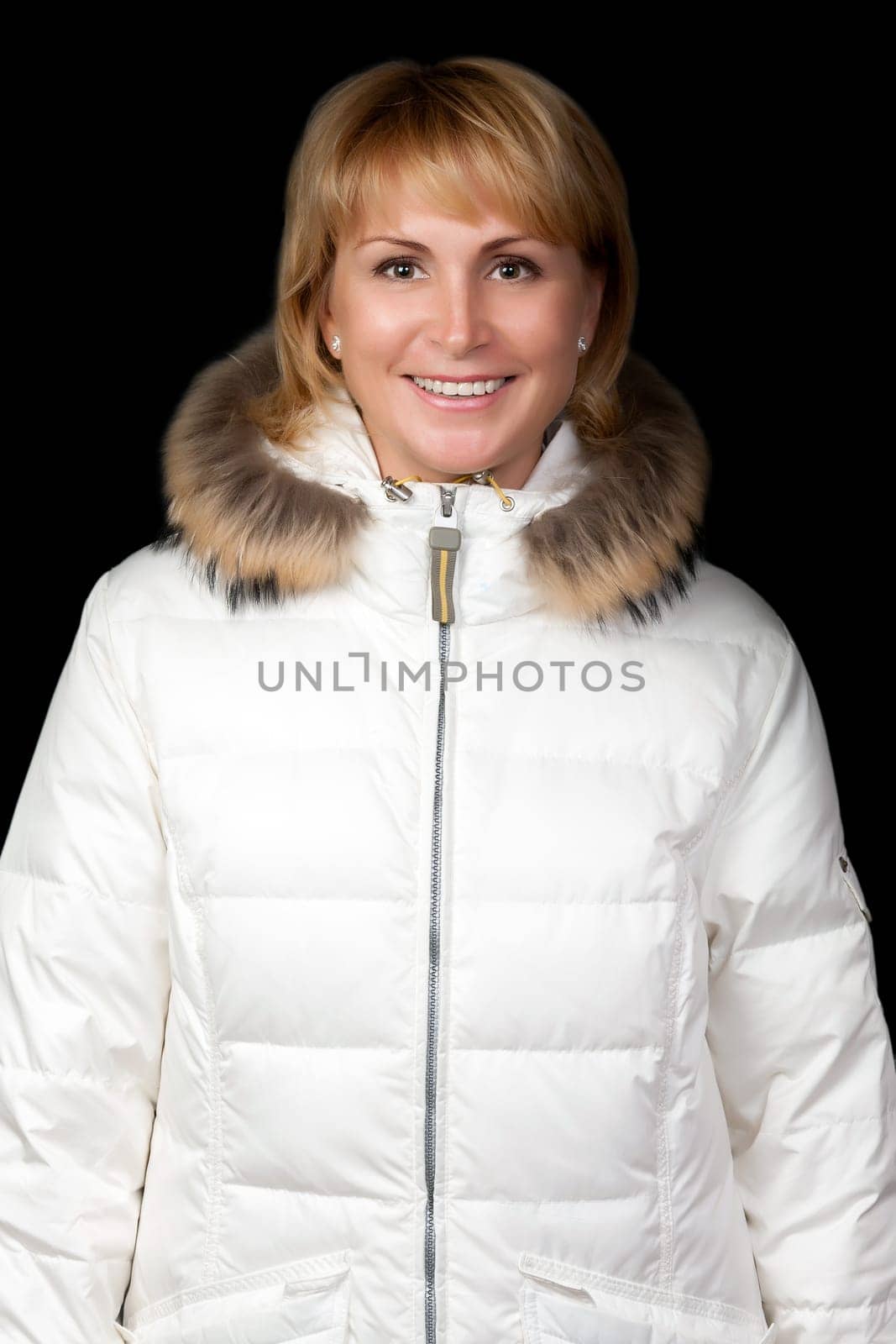 portrait of a beautiful girl in a winter jacket on a black background