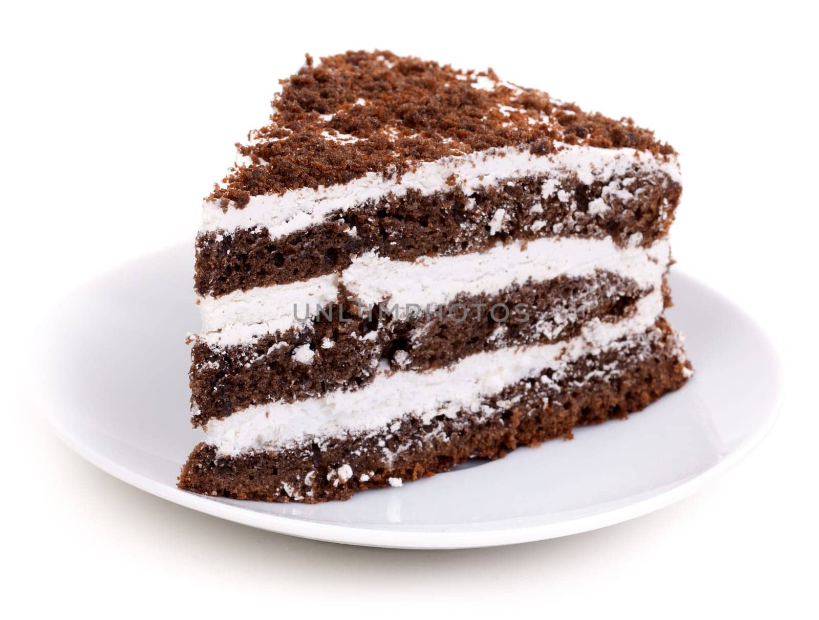 Slice of chocolate cake stuffed with whipped cream and white chocolate on white background
