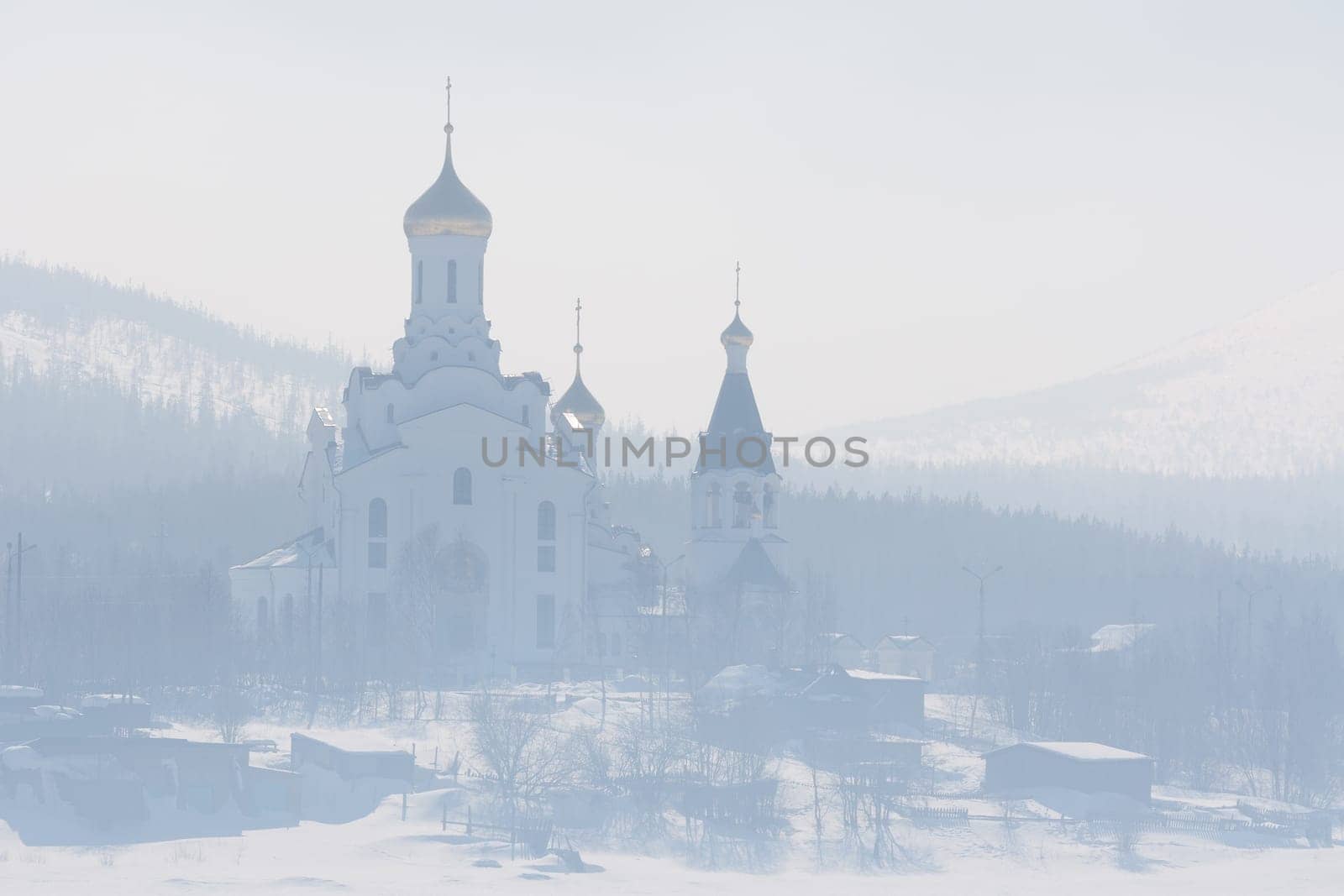 The Orthodox church with golden domes in the fog