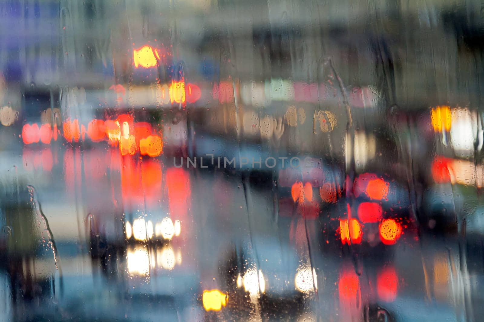 lights of the city at night through a wet glass.