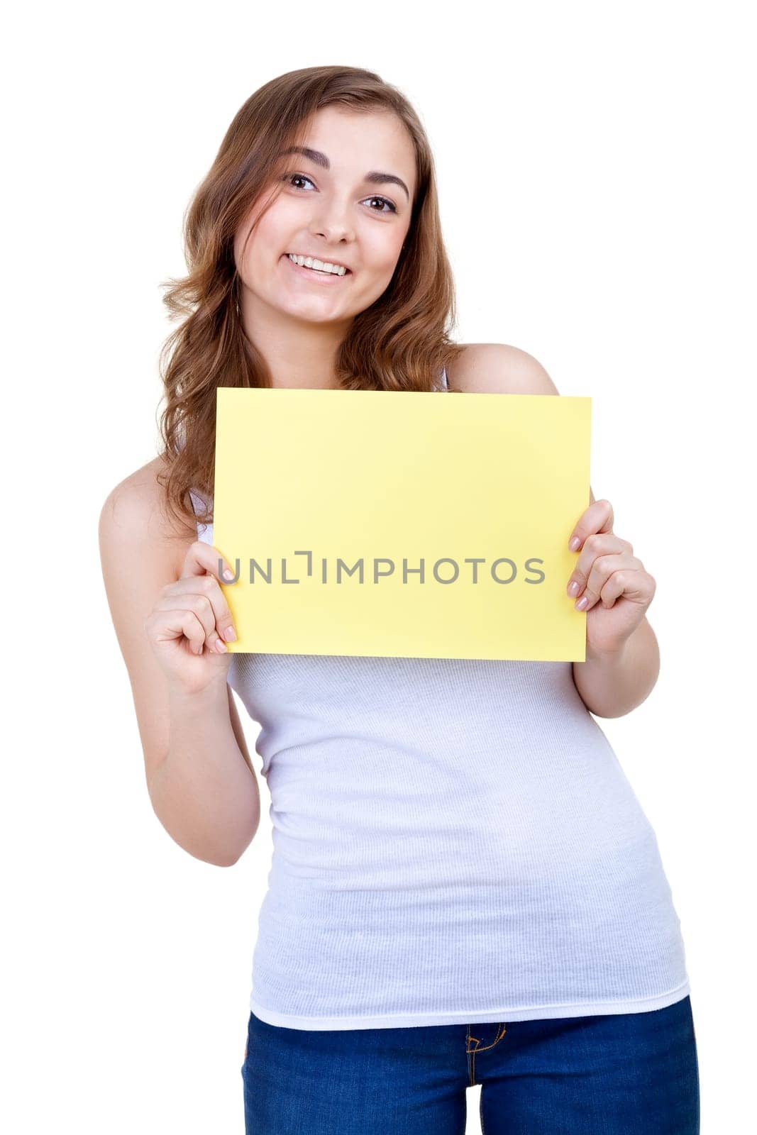 young girl shows empty sheet of a yellow paper. Isolation on the white
