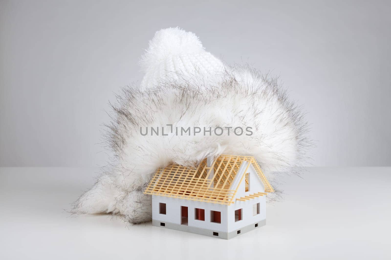 Cap isolate model of rough construction house against heat leak - unfinished house insulation concept. Prepare rough construction for winter concept.