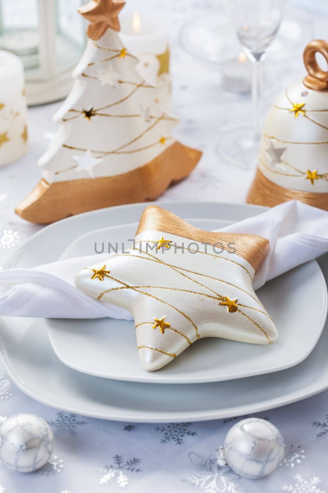Festive table for Christmas in white and golden tones