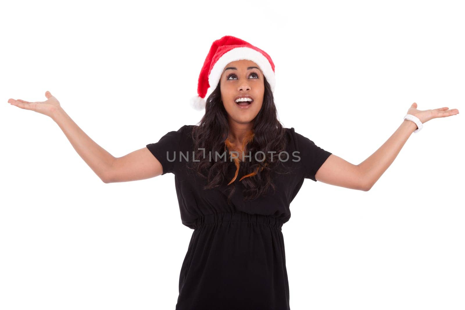 Young African American woman wearing a santa hat looking up, isolated on white background