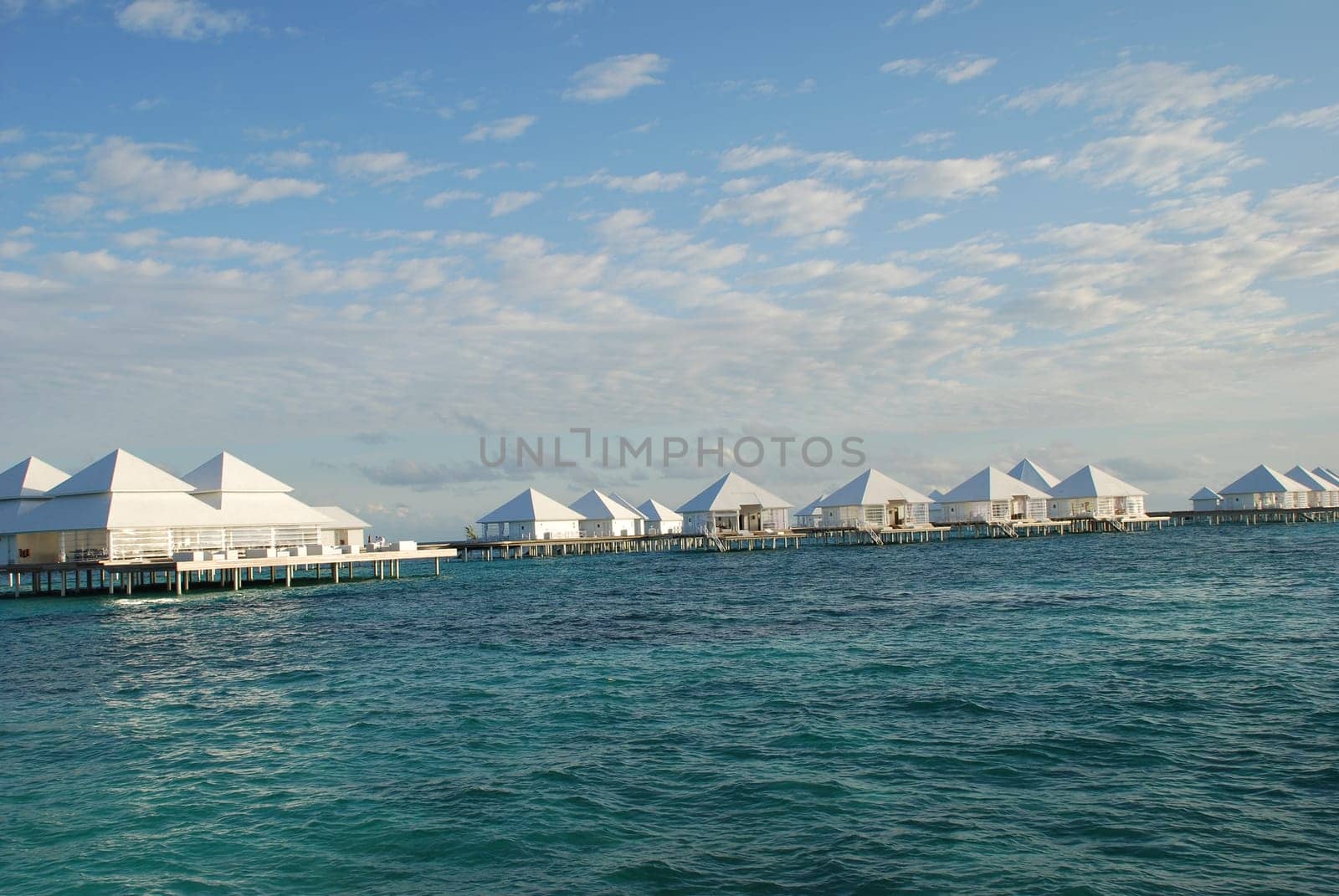 Delicate Clouds Over the Maldives Water Bungalow