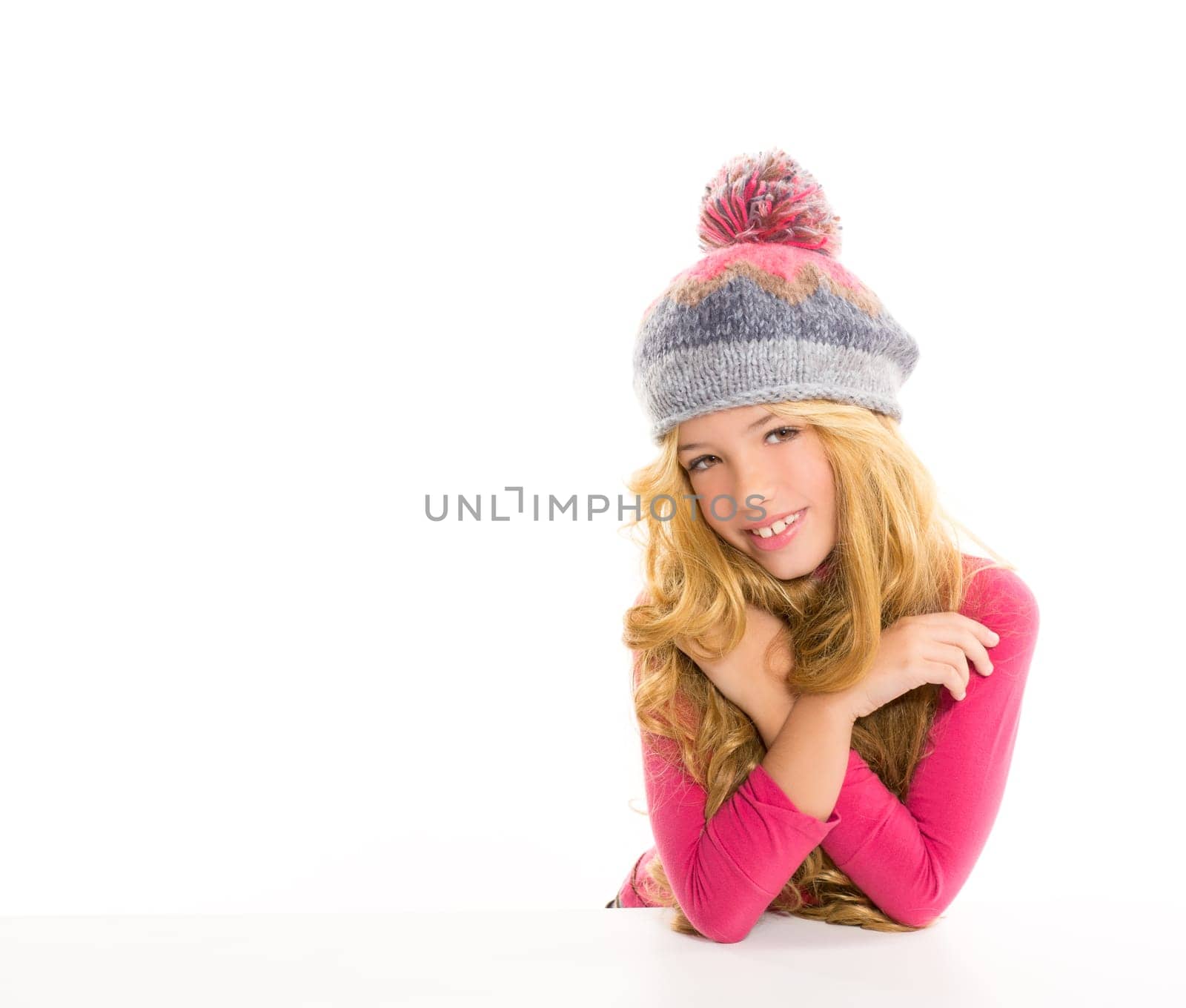Kid girl with winter wool cap happy smiling on white background
