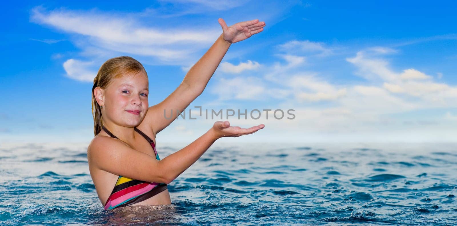 cute girl in the ocean showing the size of something