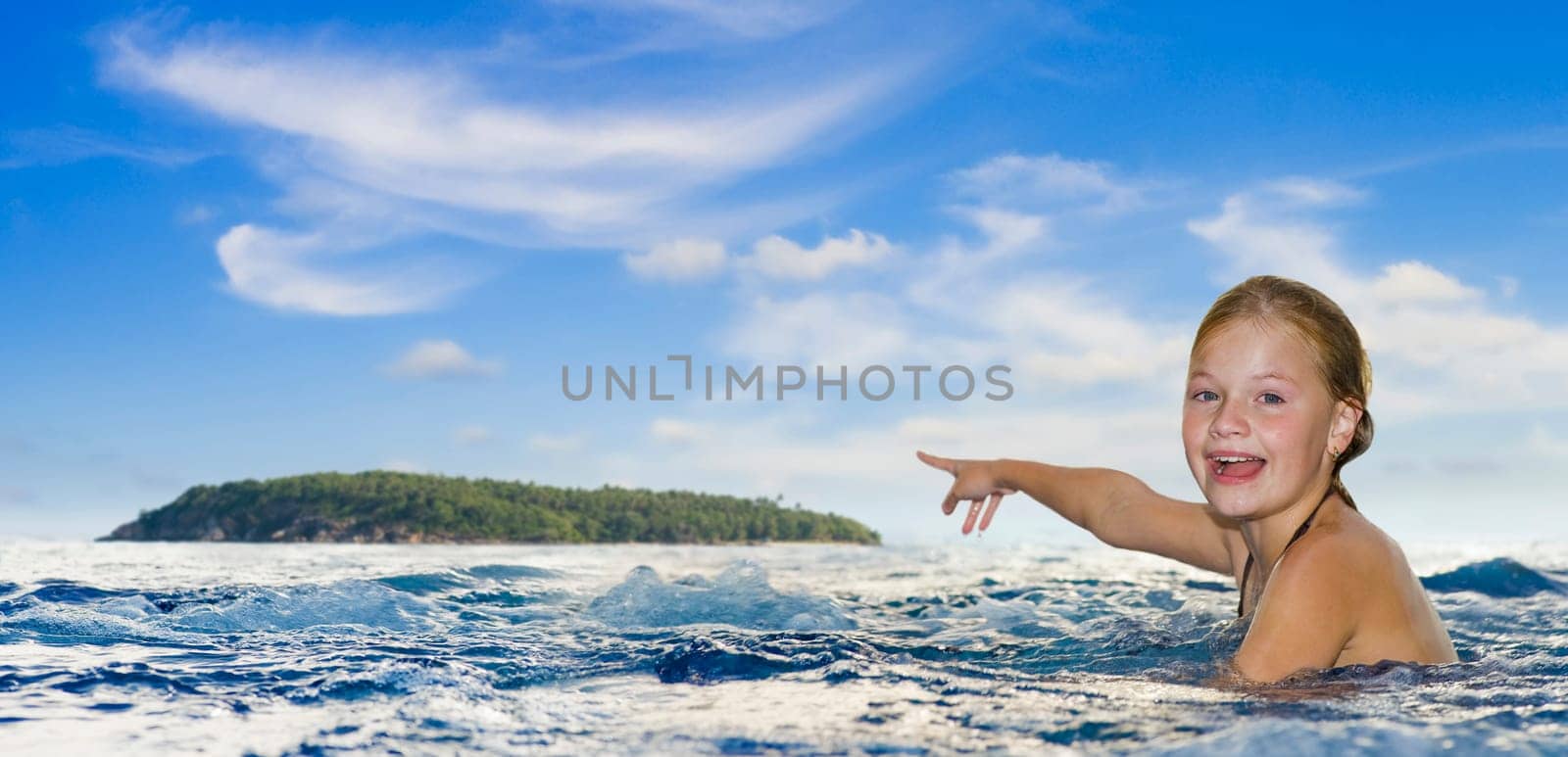 girl in the sea pointing to an island at the horizon