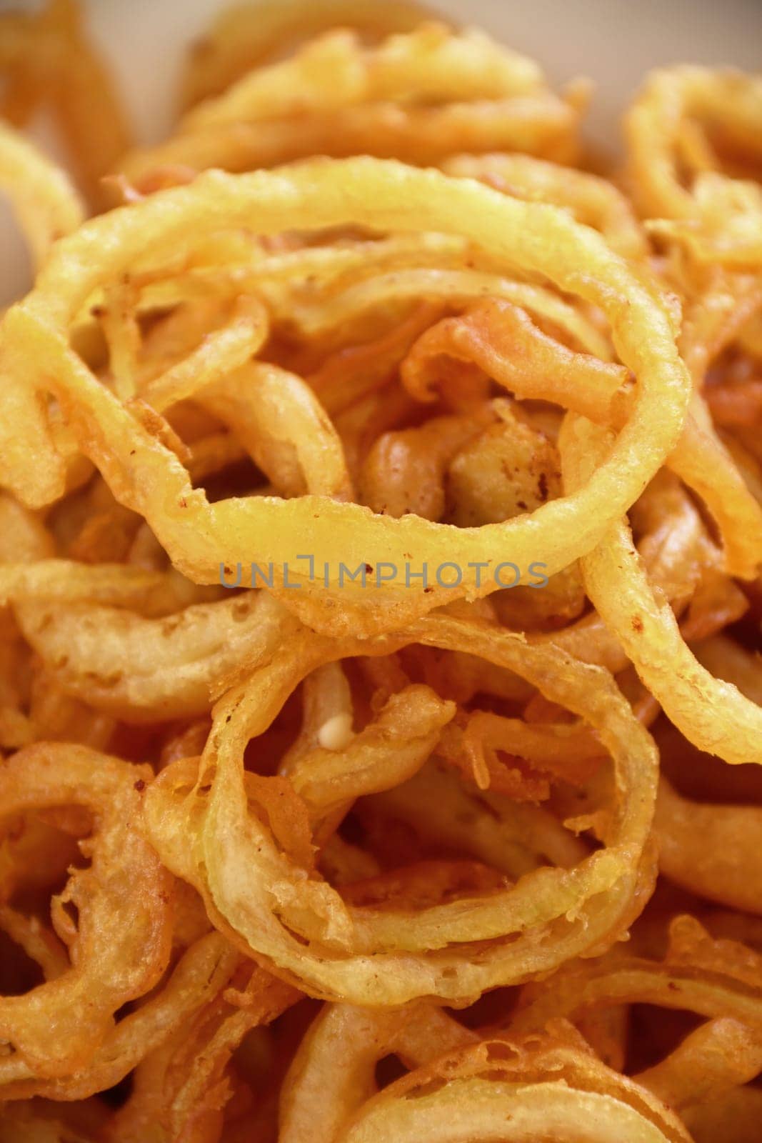 Delicious crispy onion rings fried in batter ready to serve.