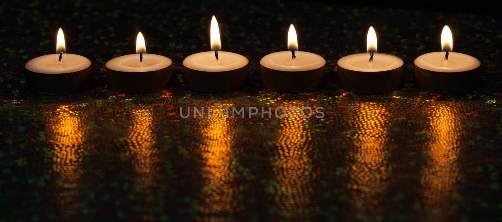 Burning candles on dark background