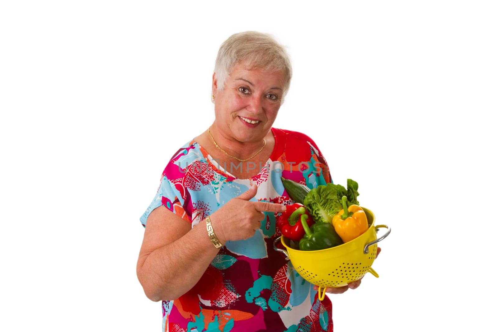 Senior woman with fresh vegetables - isolated on white background