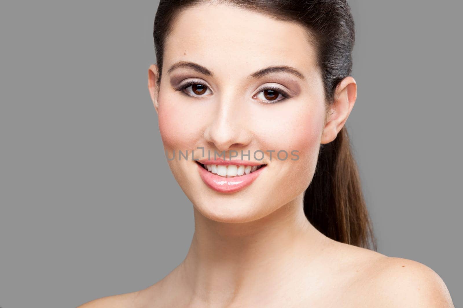 Studio portrait of a beautiful young woman smiling