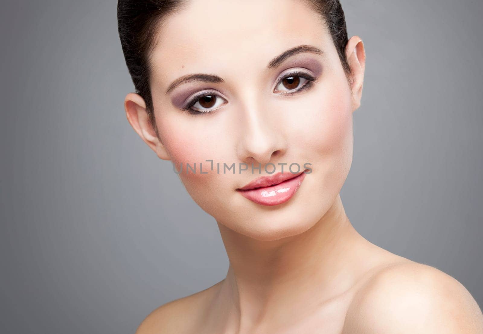 Studio portrait of a beautiful young woman smiling