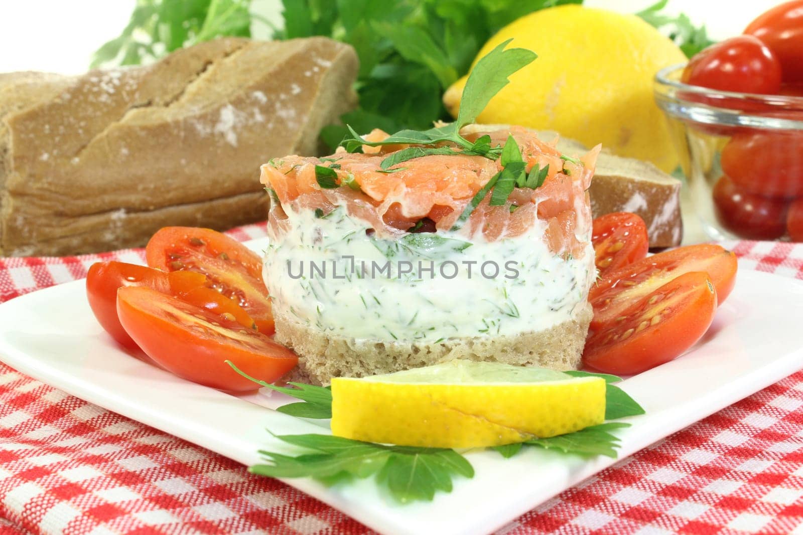 a slice of bread with herb cream and salmon tartare