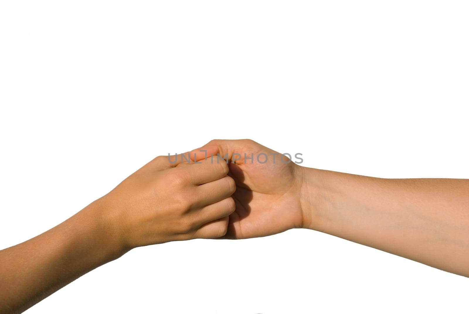 two young hands hold one another, isolated on white, aymbolizing team and strength