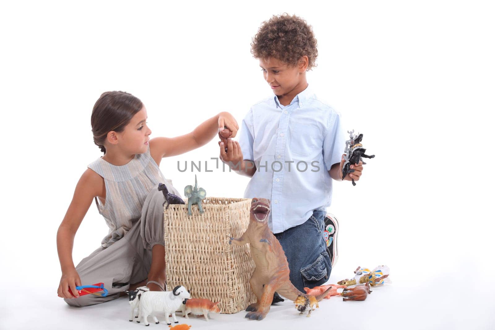 Brother and sister playing with toy animals