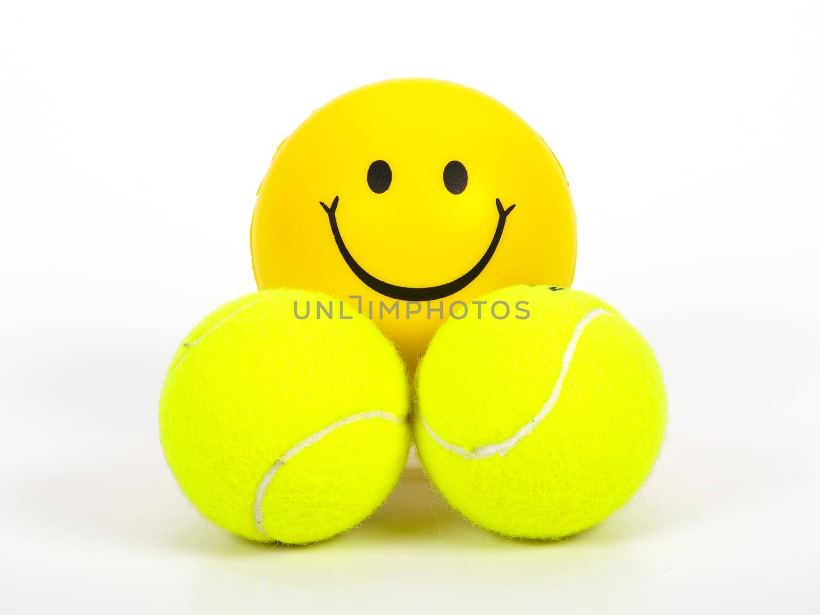 smiling tennis ball and two normal balls