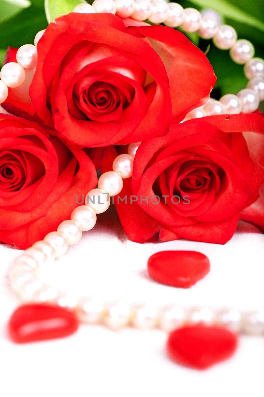 red roses with pearl necklace