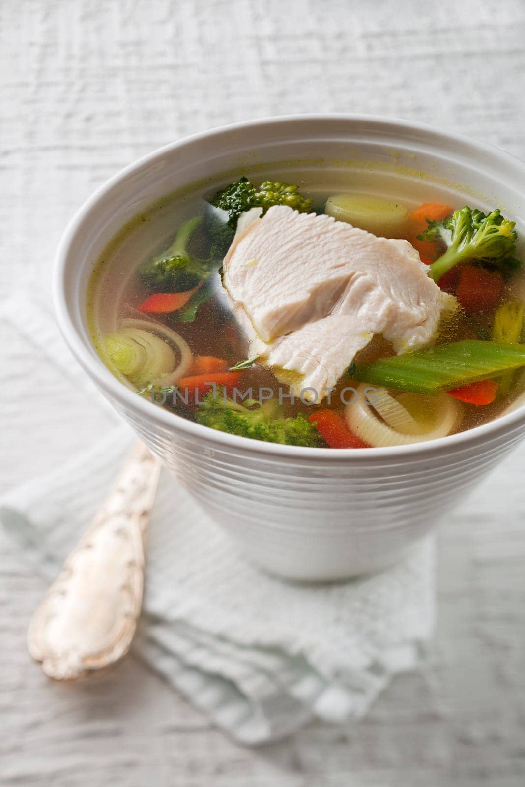 Vegetable soup with chicken meat close up