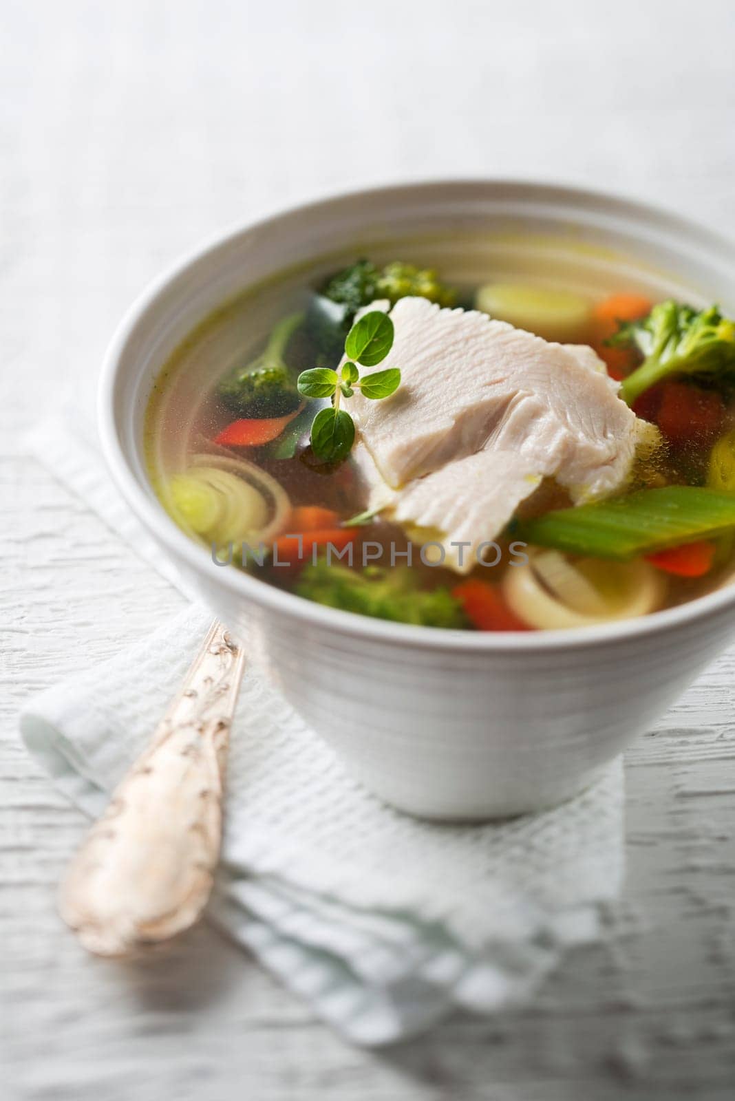Vegetable soup with chicken meat close up