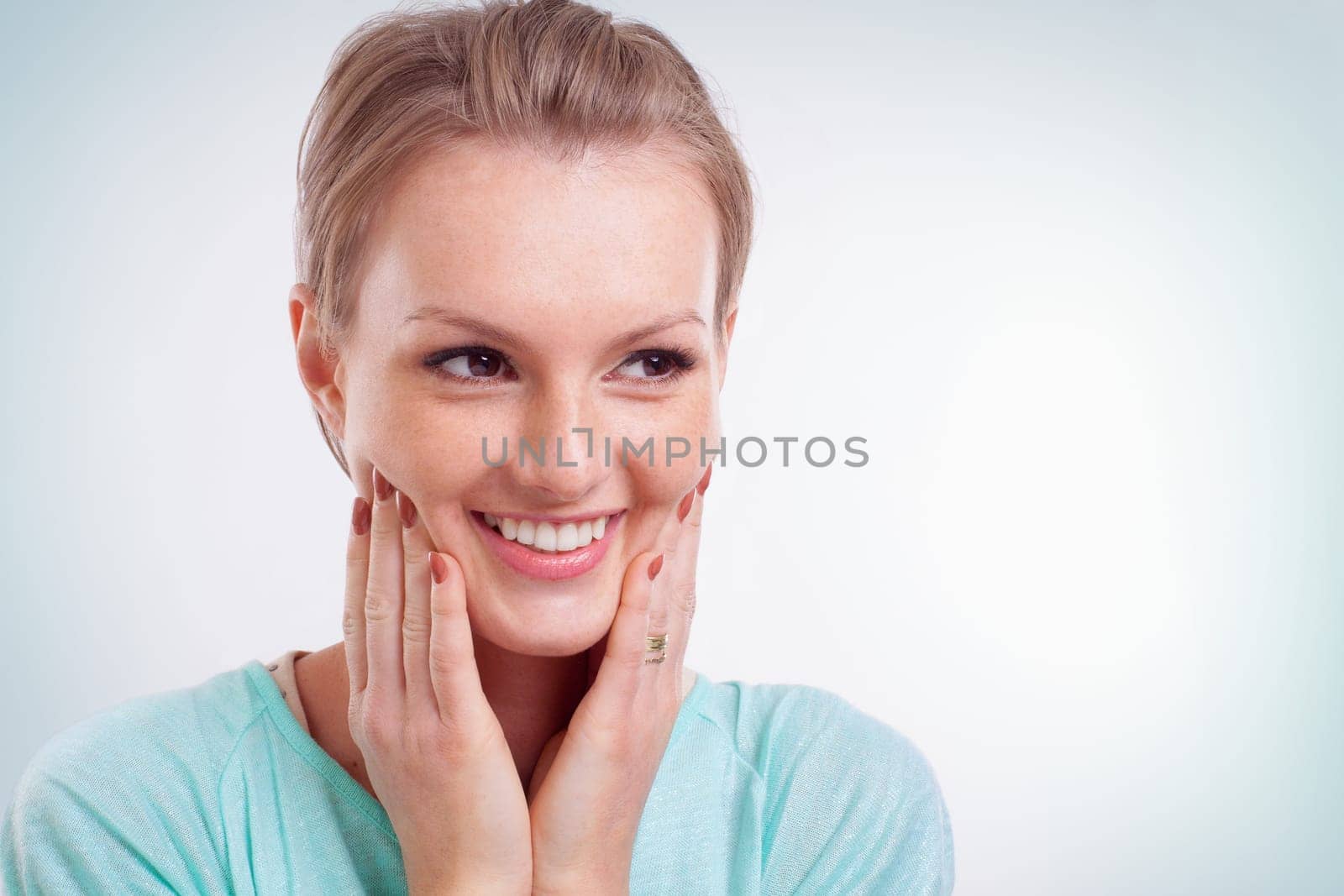 Closeup of happy young woman smiling and side looking