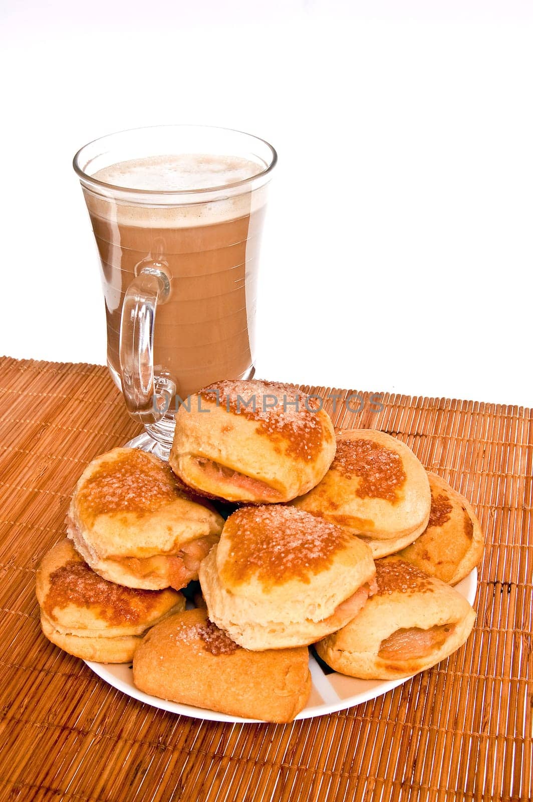 Shortbread cookies with apples and coffee for breakfast standing on a bamboo mat and white background