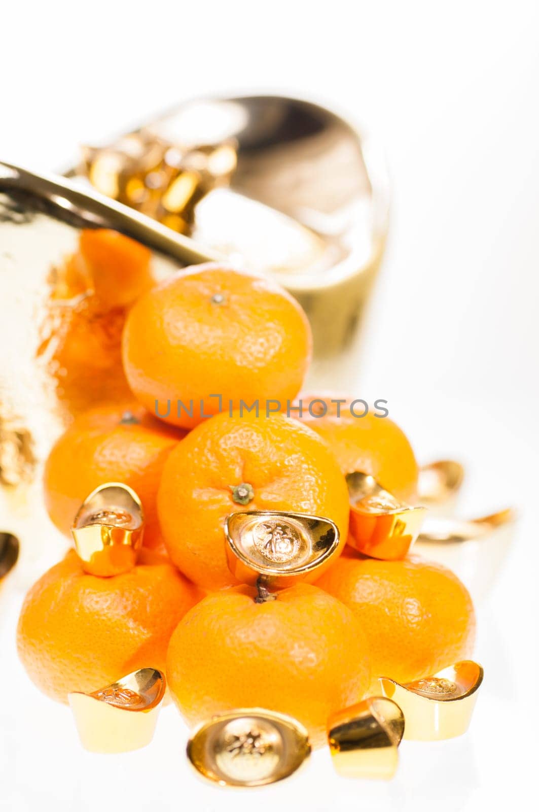 A stack of tangerine with large ingot as background
