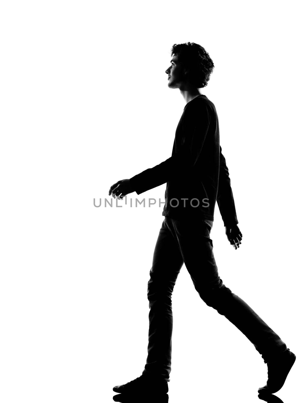 young man walking silhouette in studio isolated on white background
