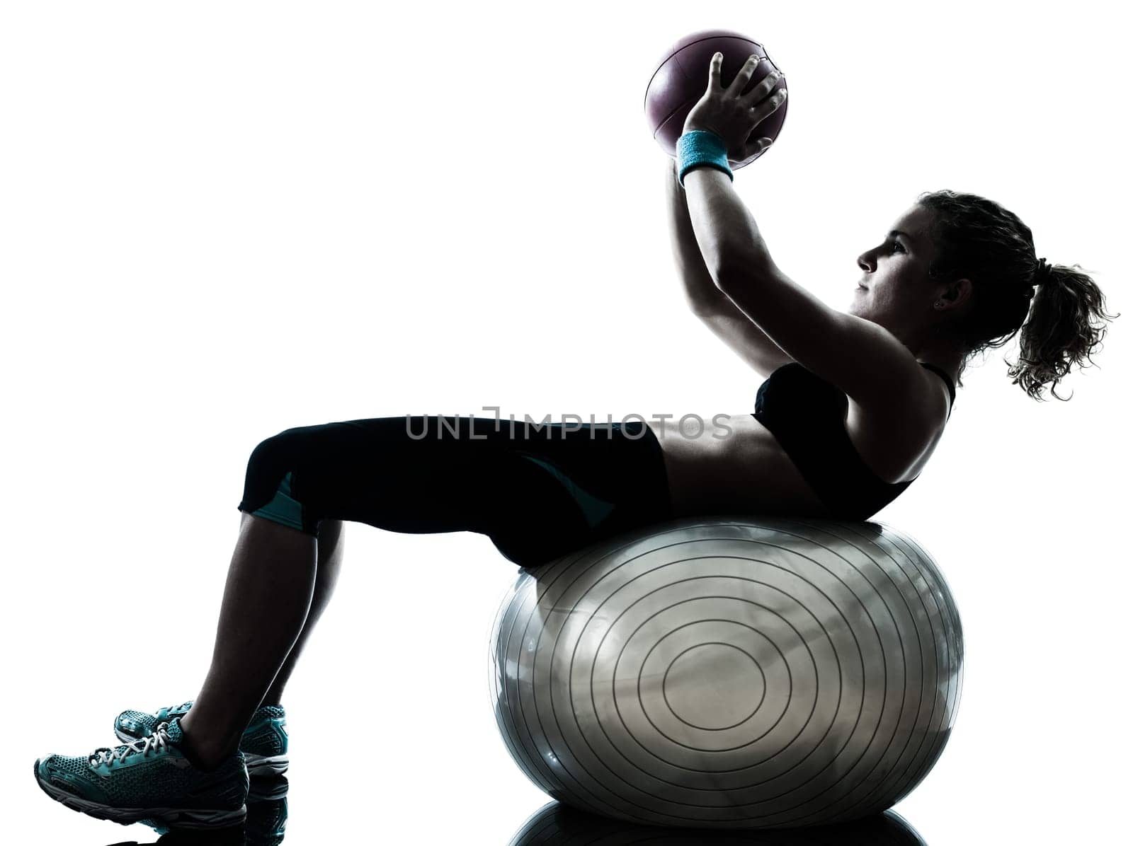 one caucasian woman exercising fitness ball workout posture in silhouette studio isolated on white background