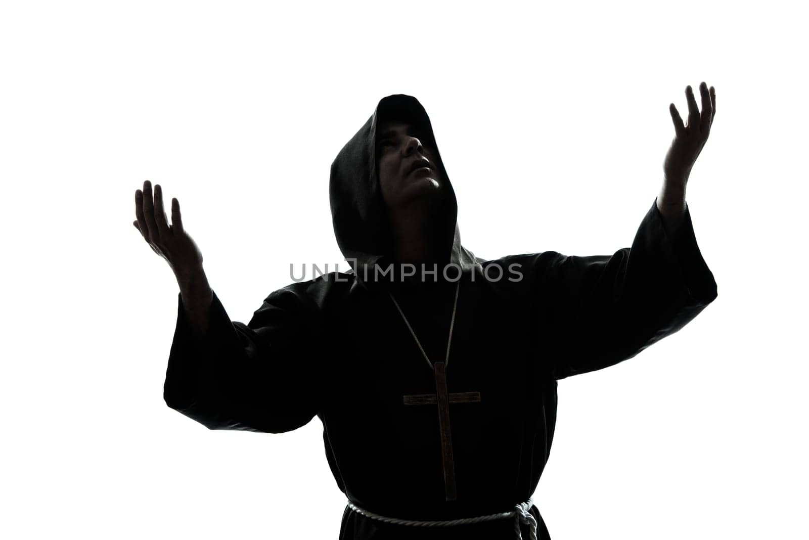 one caucasian man priest praying silhouette in studio isolated on white background