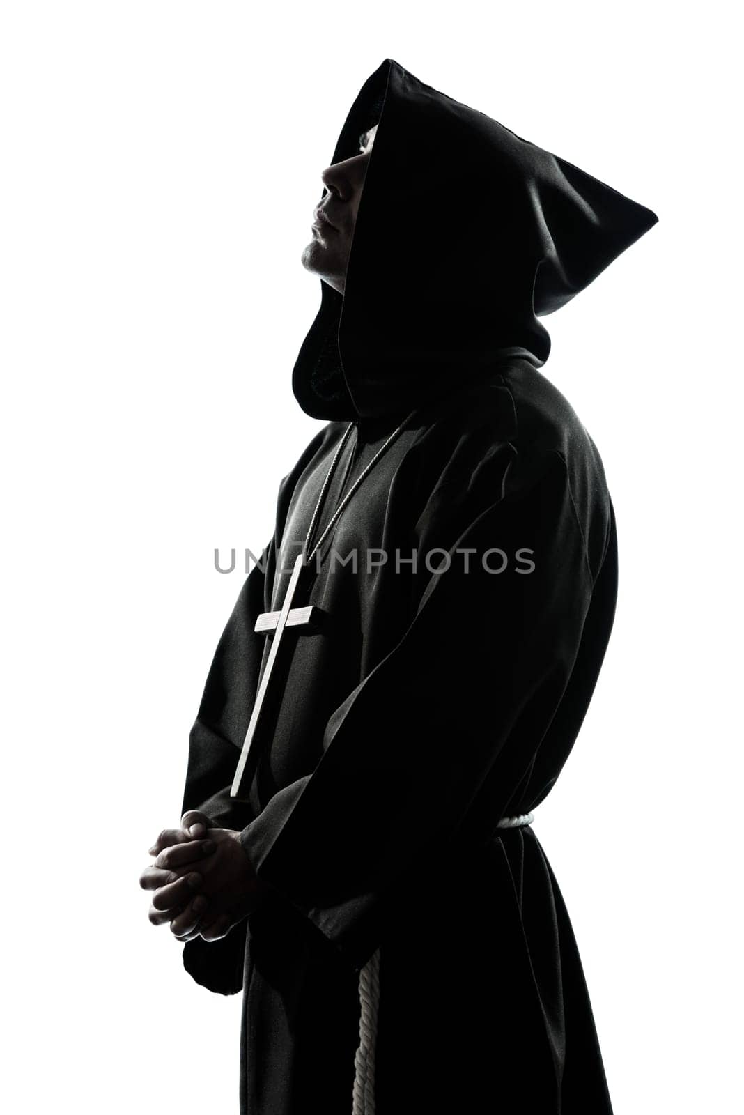 one caucasian man priest praying silhouette in studio isolated on white background
