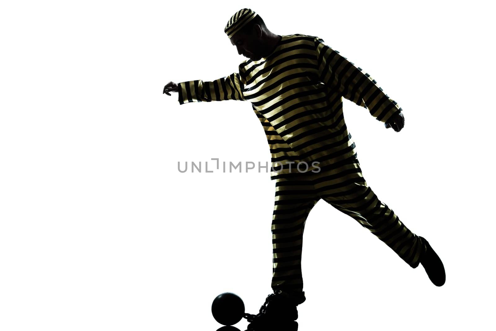 one caucasian man prisoner criminal playing soccer with chain ball in studio isolated on white background