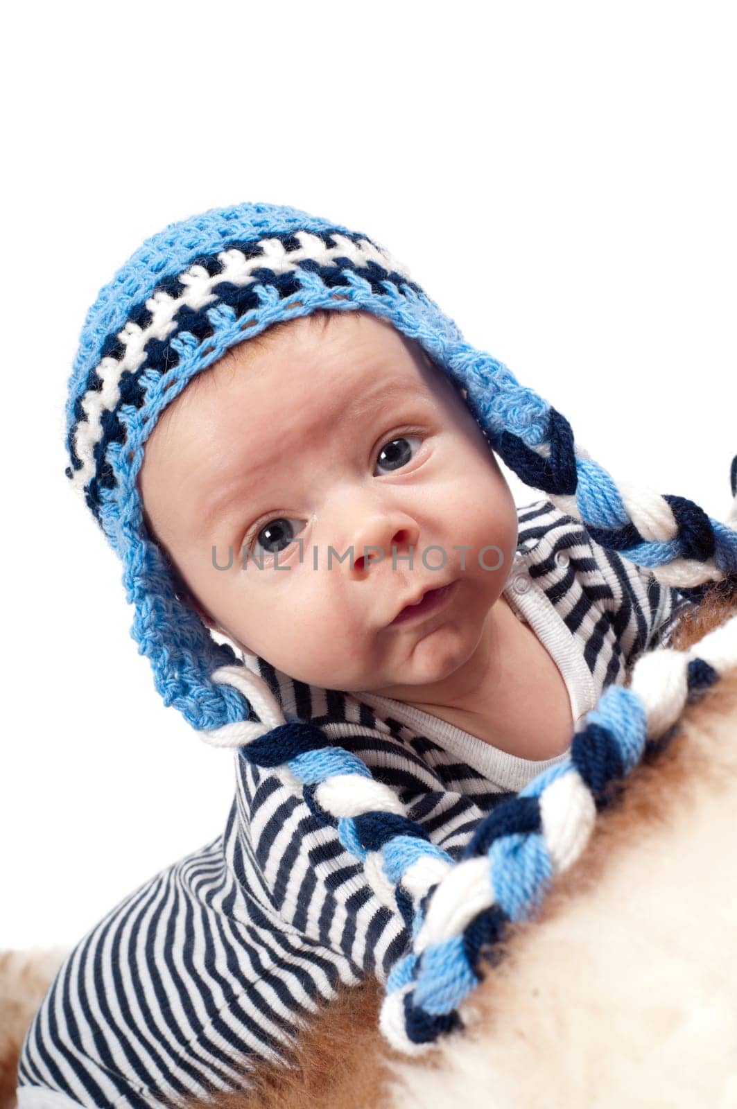 Newborn baby in blue hat and striped clothes